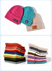 Detailed view of colorful knit beanie hats with folded cuffs and branded patches, neatly stacked.