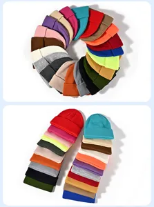 Close-up detail of vibrant colorful knit beanie color options and thick woolen warm texture.