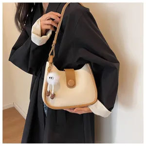 Trendy two-tone shoulder bag for women, stylish minimalist crossbody bag with cute charm.