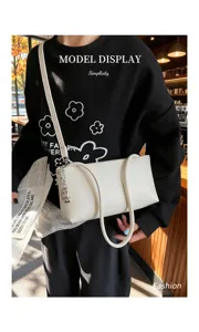 Stylish white leather baguette shoulder bag detail, versatile casual underarm bag for women.