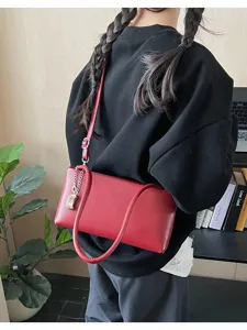 Red leather baguette shoulder bag detail, stylish underarm bag for women daily wear.