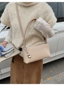 Chic minimalist beige baguette shoulder bag for women, trendy underarm daily casual purse.