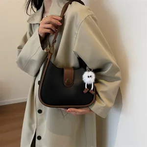 Stylish black and brown contrast shoulder bag for women, versatile daily handbag with chic fluffy pendant.