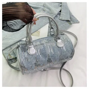 Stylish denim barrel shoulder bag with sparkling sequins and silver handle for women detail.