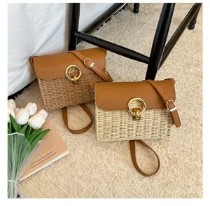 Detailed close-up view of retro straw woven shoulder crossbody bag with leather flap and metal ring.