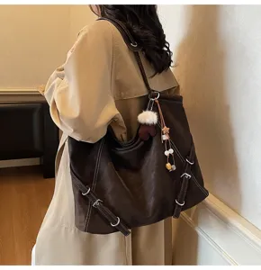Vintage brown large capacity shoulder tote bag for women, stylish commuting handbag with cute charm.
