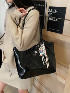 Black patent leather tote bag for women, stylish large capacity shoulder bag for daily commute.