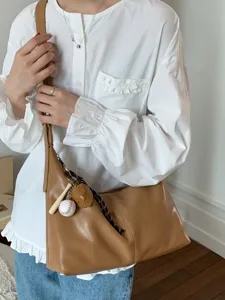 Casual brown shoulder bag for women, large capacity minimalist daily commute crossbody bag.