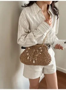 Stylish straw woven shoulder bag for women, trendy beach crossbody bag with shell chain design.