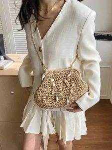 Woven straw shoulder bag for women, trendy beach crossbody handbag with chain and shells.