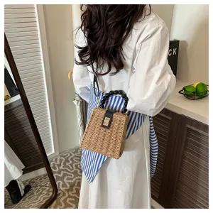 Retro straw crossbody bag with beaded handle and metal lock. Stylish beach woven handbag.