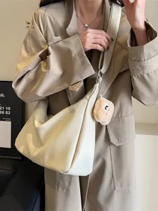 Women casual solid color PU leather hobo crossbody shoulder bag with cute plush pendant.