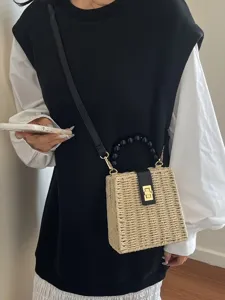 Retro straw woven shoulder bag with beaded handle and chic metal lock for summer beach style