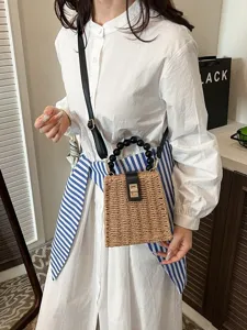 Vintage woven straw crossbody bag with black beaded handle and metal lock for women summer.