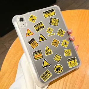 Close-up detail of transparent tablet case featuring funny warning sign stickers design.