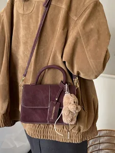 Retro suede crossbody bag, purple top handle small square bag with cute bear pendant.