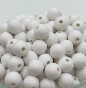 Close-up detail view of white glossy round acrylic beads for DIY craft jewelry making.