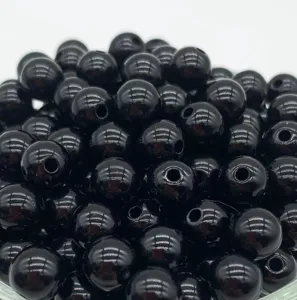 Glossy black acrylic round beads featuring straight holes, perfect for DIY jewelry crafting.