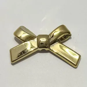 Gold color bow shape DIY craft bead accessory, straight hole design for phone chains and jewelry.