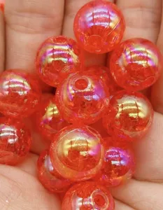 Close-up detail of vibrant orange cracked acrylic bubble beads with AB rainbow iridescent coating.