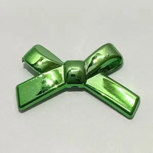 Green UV plated bowknot charm bead detail shot, ideal for DIY phone chain crafting.