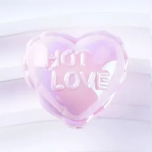 Close-up detail of the glossy iridescent pink heart bead charm with embossed love text.