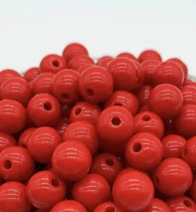 Close-up detail of glossy red acrylic round loose beads, perfect for DIY jewelry making.