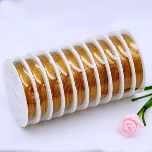 Golden craft wire spools for DIY beading, jewelry making, and handmade bracelet accessories.