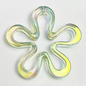 Detailed view of iridescent hollow flower bead, UV coated DIY charm for phone chains and jewelry.