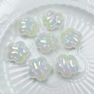 Close-up detail of iridescent acrylic UV wave beads for DIY jewelry and phone charms.