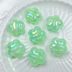 Green iridescent acrylic plum blossom beads detail showing UV wave surface for DIY jewelry making.