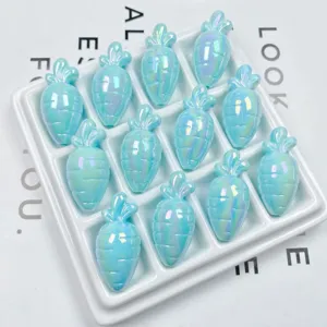 Close-up of iridescent acrylic carrot beads in white tray for DIY handmade phone chain.