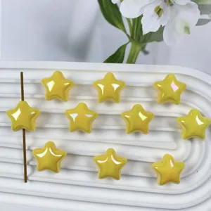 Close-up of 20mm iridescent star acrylic beads, glossy yellow DIY handmade jewelry accessory.