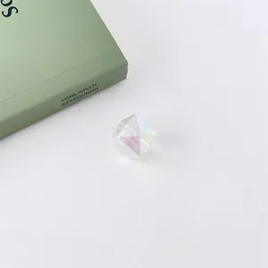 Close-up detail of iridescent faceted acrylic bead with colorful UV coating for DIY jewelry making.