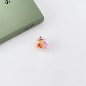 Close-up detail of iridescent acrylic diamond faceted bead with UV plating and colorful sparkle.