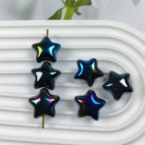 Detailed close-up view of shiny iridescent star acrylic beads displayed on white tray.