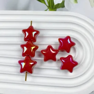 Detailed shot of glossy red iridescent star acrylic loose beads for DIY handmade jewelry crafts.