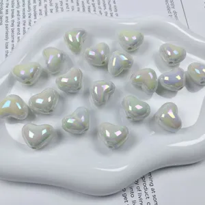 Acrylic AB color heart shaped loose beads detail shot for DIY handmade jewelry making crafts.