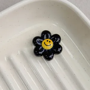 Black resin smiley flower charm detail, perfect for DIY jewelry making and cute craft accessories.