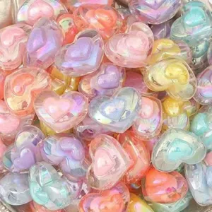 Close-up detail of iridescent AB-plated double-layer heart acrylic beads for DIY crafting.