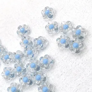 Clear acrylic flower shaped beads with blue core for DIY jewelry making detail view