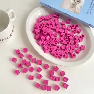 Detailed view of pink acrylic square letter beads, perfect for DIY jewelry making accessories.