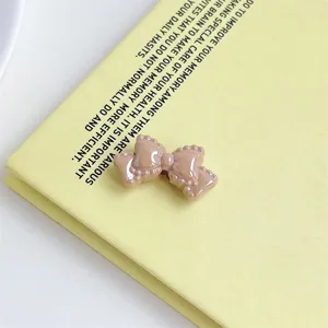 Acrylic cream bow detail shot, perfect for DIY phone charms, keychains and cute hair accessories.
