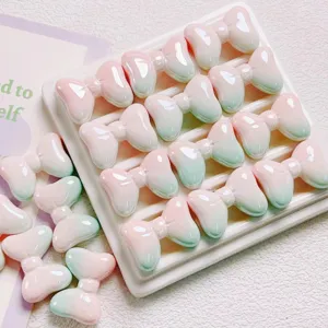 Gros plan de perles nœud en acrylique dégradé pastel brillant pour bijoux et accessoires DIY.