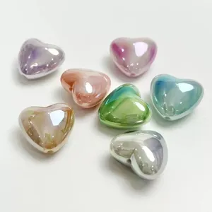 Close-up detail of colorful gradient heart-shaped beads for DIY phone chains and bracelets.