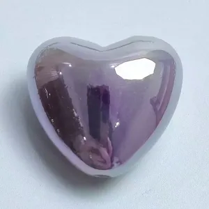 Close-up detail of the iridescent heart bead, perfect for DIY phone charms and custom jewelry.
