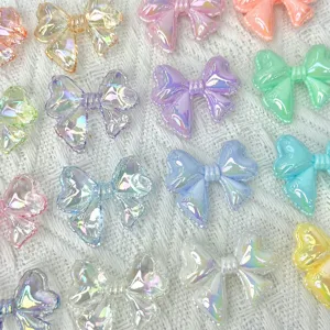 Colorful iridescent acrylic bow beads detail shot, perfect for DIY jewelry making accessories.