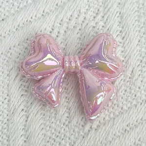 Pink iridescent balloon bow acrylic DIY charm for handmade bracelets and jewelry making.