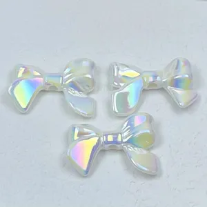 Close-up of iridescent acrylic bow beads, colorful holographic DIY craft accessories for phone charms.
