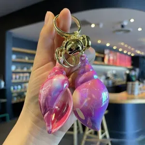 Colorful electroplated acrylic conch shell keychain pendant with gold bell for bags and car keys.